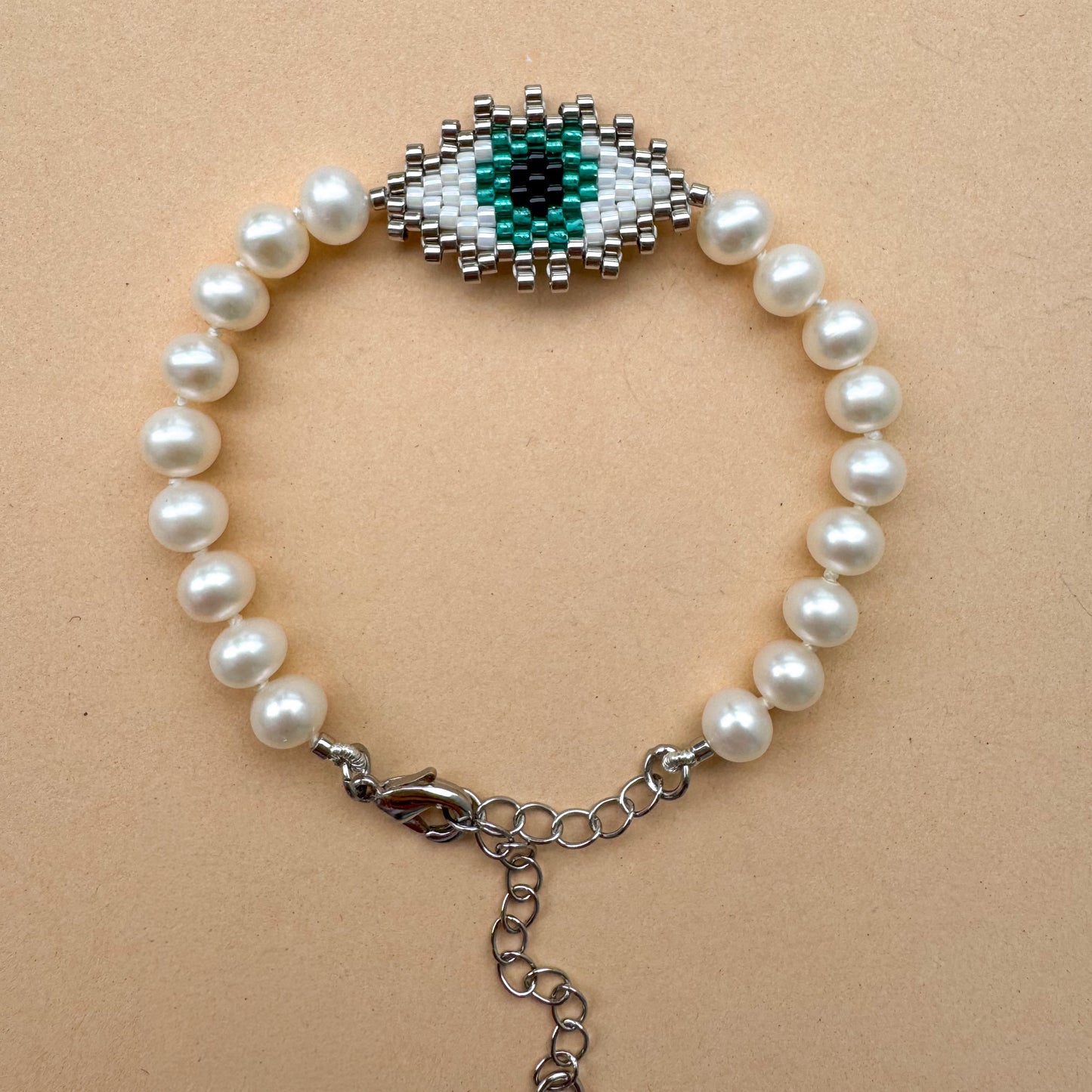 Evil eye bracelet with mate freshwater pearls