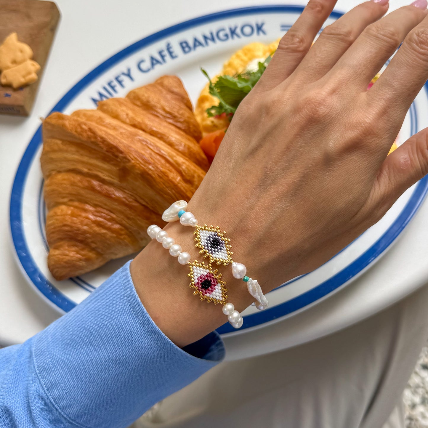 Evil eye bracelet with mate freshwater pearls